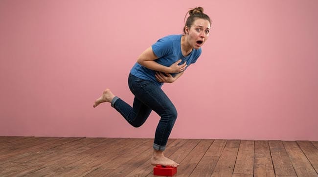 a woman step foot on a lego brick