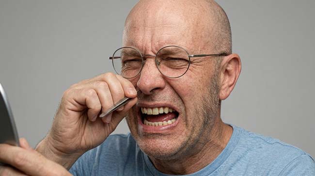 A person is picking his nose hair